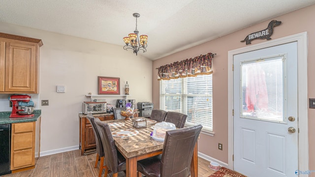 dining space featuring an inviting chandelier, wood finished floors, baseboards, and a textured ceiling