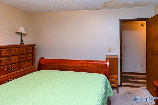 carpeted bedroom with a textured ceiling