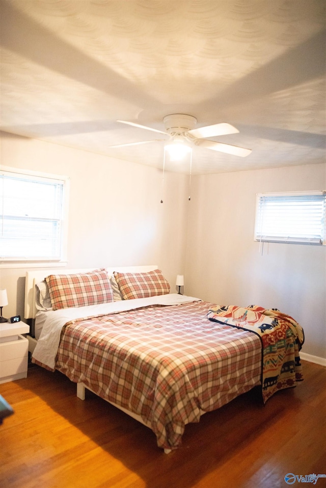 1709 Iris SW, Decatur, AL 35601 - bedroom with wood finished floors, multiple windows, and a ceiling fan