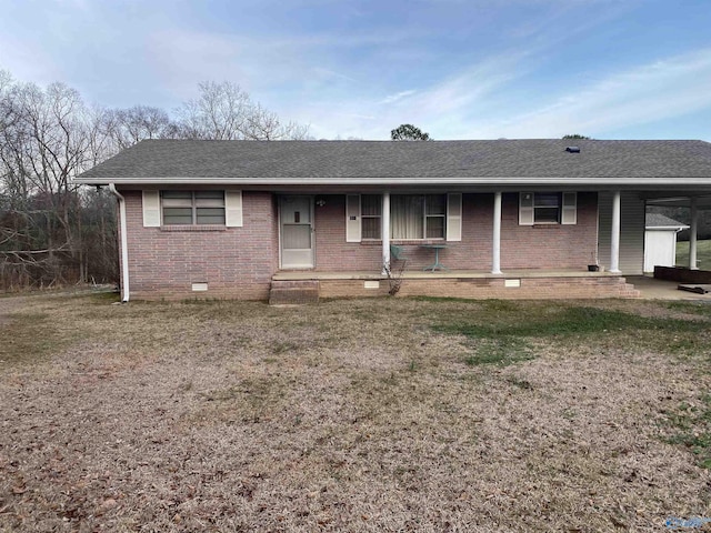 single story home with a carport, a porch, and a front yard