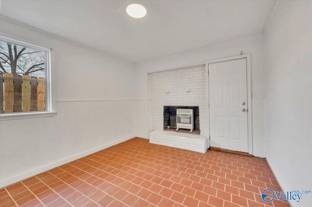 unfurnished living room with baseboards