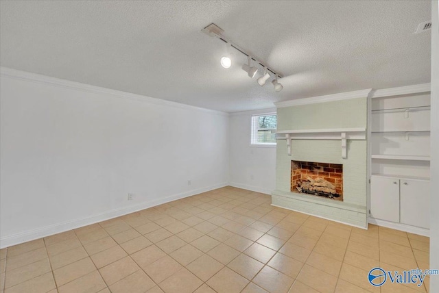 unfurnished living room with visible vents, ornamental molding, a textured ceiling, a fireplace, and baseboards