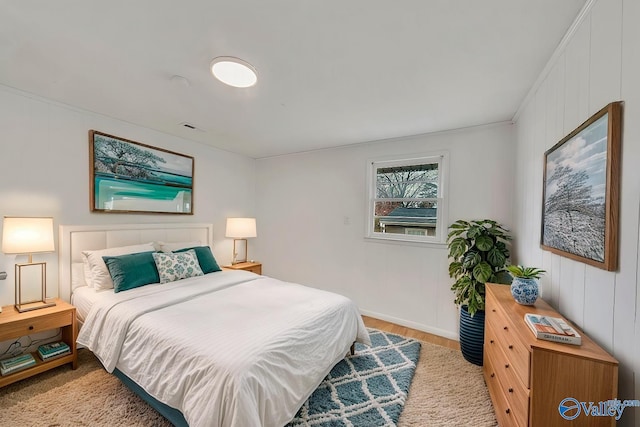 bedroom with visible vents and wood finished floors