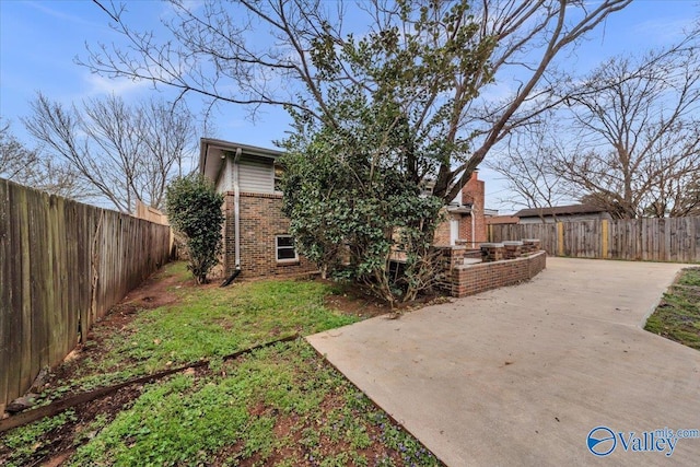 view of yard with a patio area and a fenced backyard