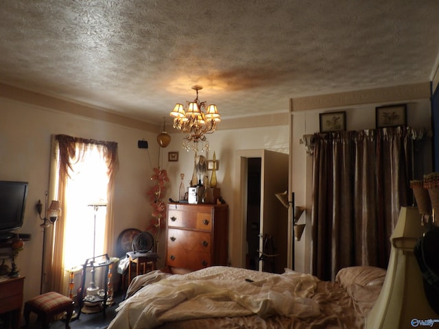 bedroom featuring a notable chandelier and a textured ceiling