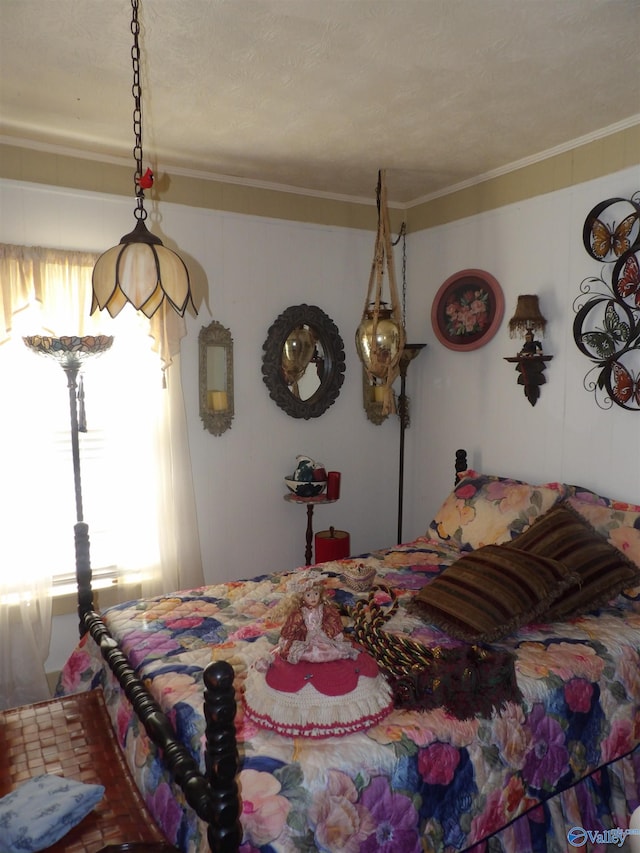 bedroom with crown molding and a textured ceiling