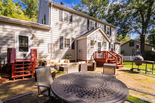 back of house featuring a lawn and a deck