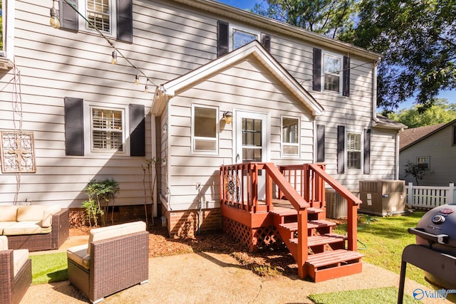 back of house with cooling unit and a wooden deck