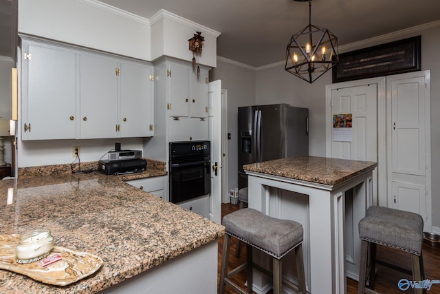 kitchen with dark wood-type flooring, white cabinetry, an inviting chandelier, oven, and ornamental molding