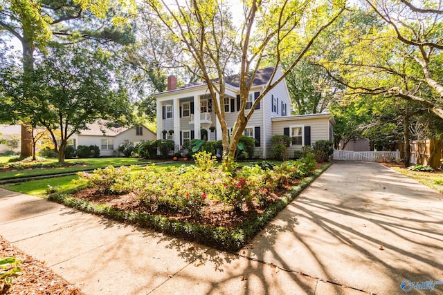815 Sherman St SE, Decatur, AL 35601 - neoclassical home featuring fence, a chimney, and concrete driveway