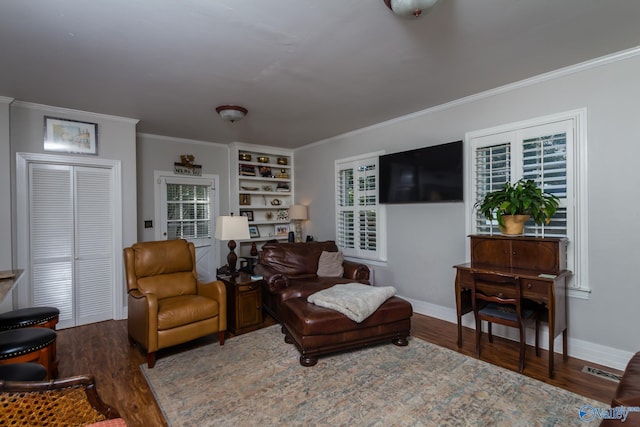 815 Sherman St SE, Decatur, AL 35601 - living area featuring wood finished floors, ornamental molding, baseboards, and built in shelves
