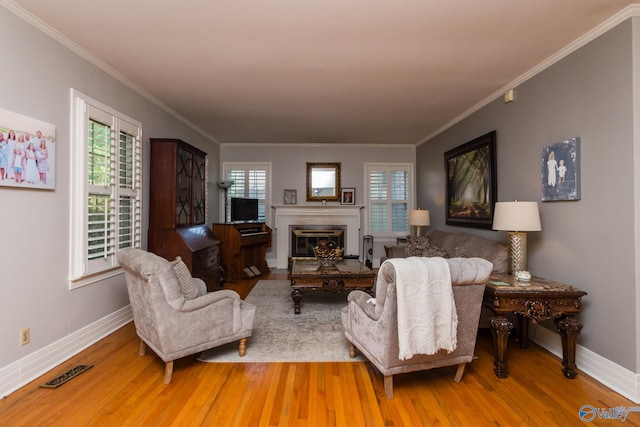 living room featuring light wood-type flooring and ornamental molding