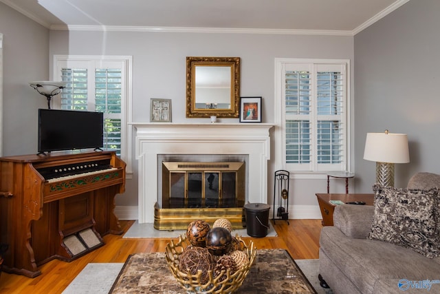 living room featuring light hardwood / wood-style flooring and crown molding