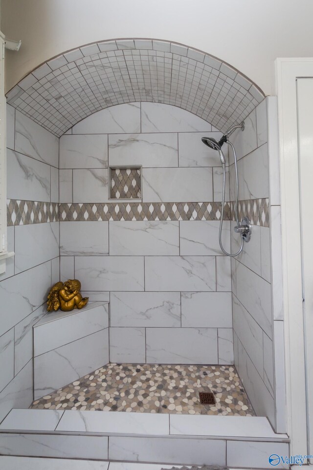 bathroom with tiled shower