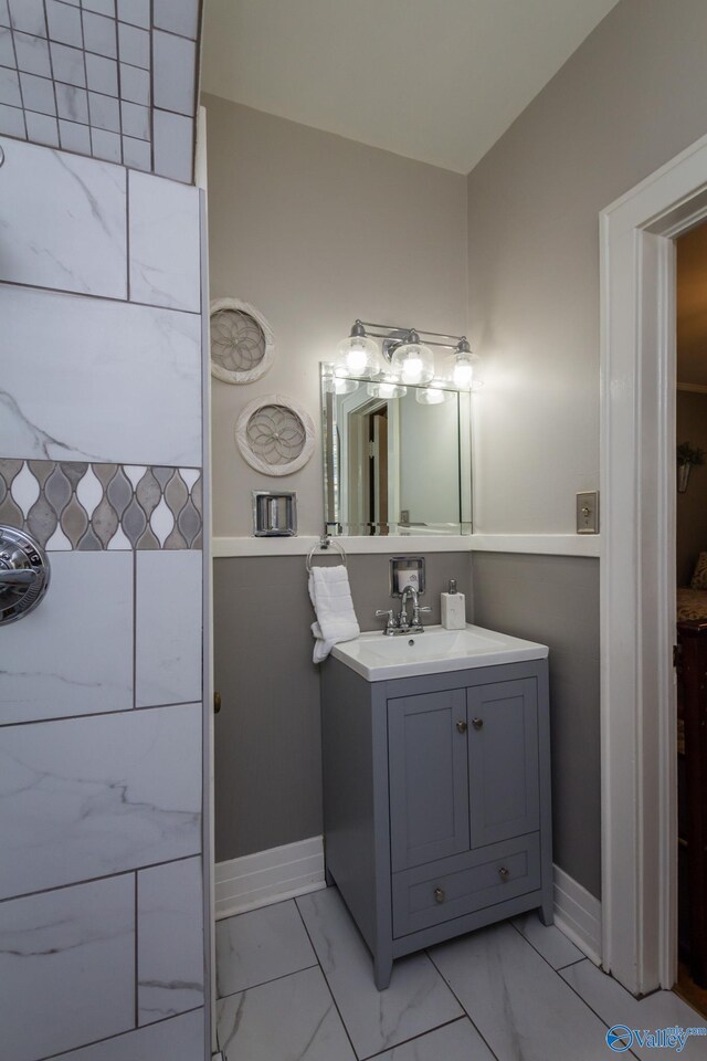 815 Sherman St SE, Decatur, AL 35601 - bathroom with marble finish flooring, baseboards, and vanity