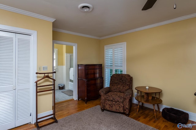 living area featuring ceiling fan, hardwood / wood-style flooring, and ornamental molding