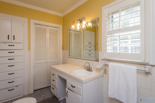 bathroom featuring ornamental molding, tile walls, tile patterned floors, and vanity