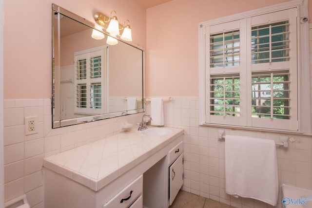 bathroom with vanity, tile walls, and tile patterned flooring