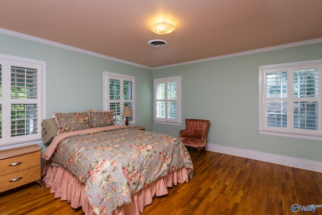 bedroom with multiple windows, ornamental molding, and dark wood-type flooring