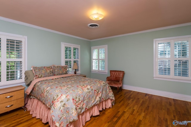 815 Sherman St SE, Decatur, AL 35601 - bedroom with ornamental molding, dark wood-type flooring, and baseboards