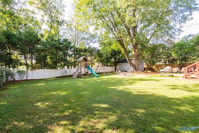 view of yard with a playground and a patio