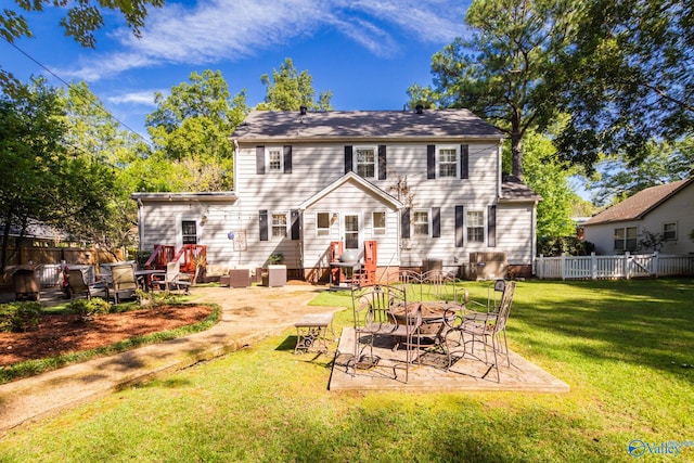 rear view of property with a patio and a yard