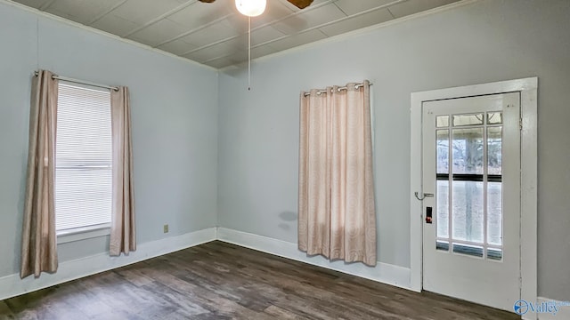 unfurnished room featuring ceiling fan, crown molding, and dark hardwood / wood-style flooring