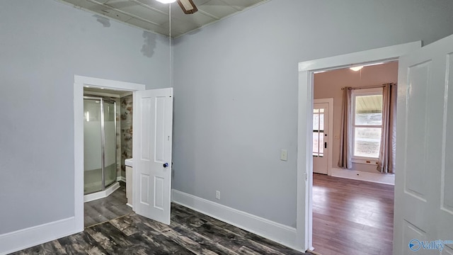 interior space with dark wood-type flooring and ceiling fan