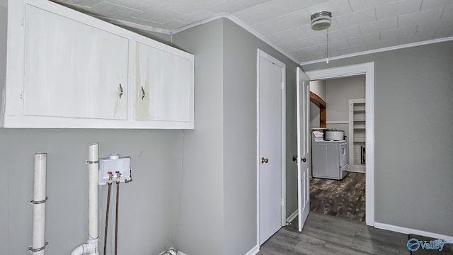 washroom featuring hardwood / wood-style flooring, crown molding, and cabinets