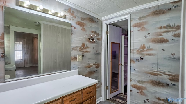 bathroom with crown molding and vanity