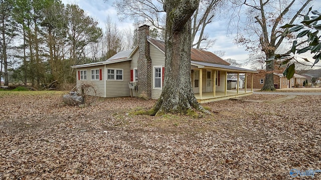 view of property exterior with covered porch