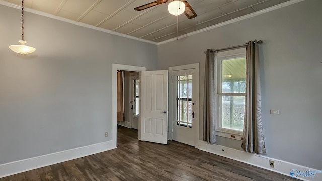 empty room featuring crown molding, dark wood-type flooring, and ceiling fan