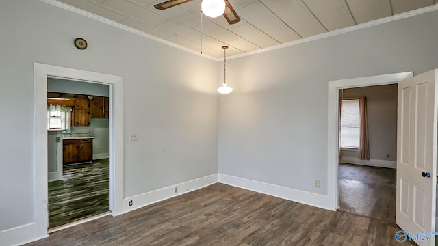 unfurnished room featuring dark wood-type flooring, ceiling fan, and ornamental molding