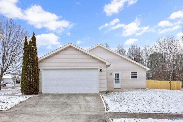 ranch-style house with fence, driveway, and an attached garage