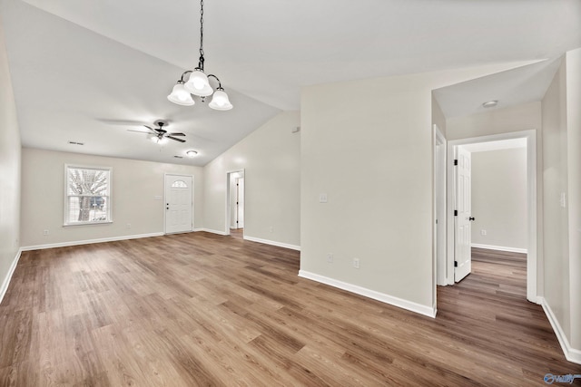 unfurnished living room featuring baseboards and wood finished floors