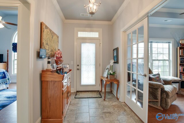 entryway with light tile patterned floors, ceiling fan, french doors, and crown molding