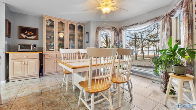 dining area with ceiling fan and light tile patterned floors