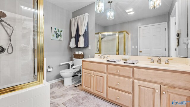 bathroom with toilet, an enclosed shower, and vanity