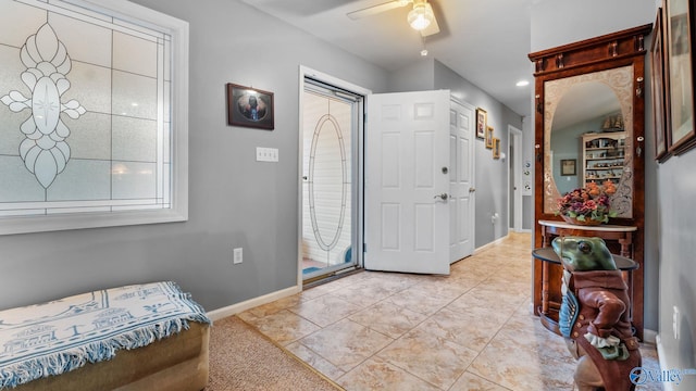 tiled entrance foyer with ceiling fan