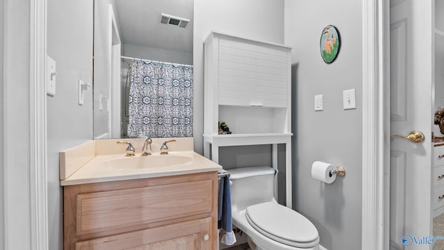 bathroom with toilet and vanity