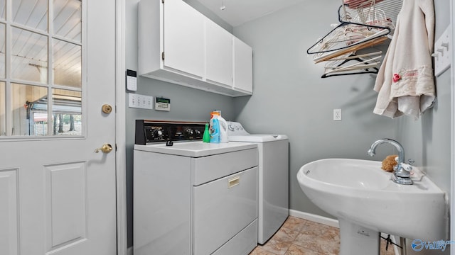 laundry area featuring sink, cabinets, and washing machine and dryer