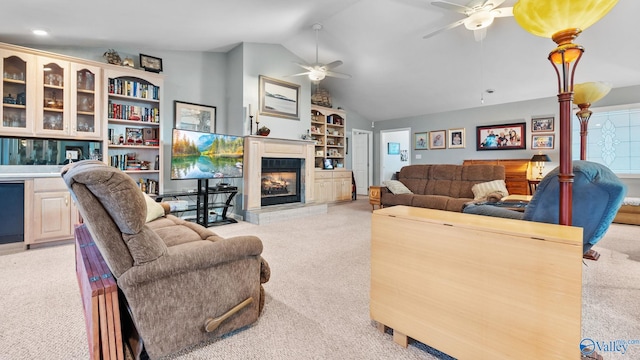 living room featuring vaulted ceiling, ceiling fan, and light colored carpet