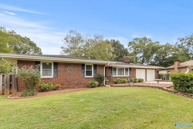 ranch-style house with a chimney, an attached garage, fence, a front lawn, and brick siding