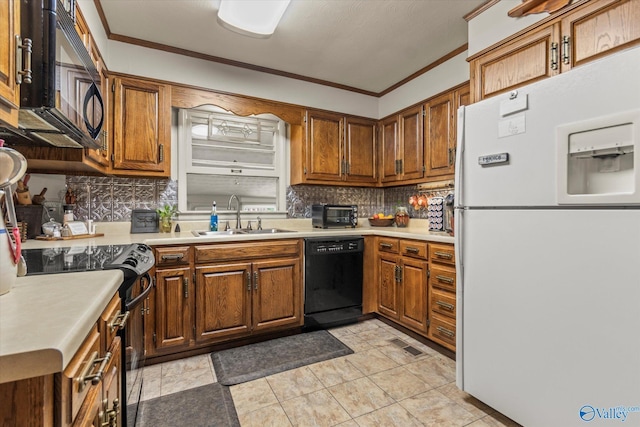 kitchen featuring black appliances, ornamental molding, a sink, and light countertops