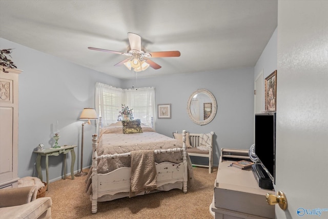 carpeted bedroom featuring baseboards and a ceiling fan