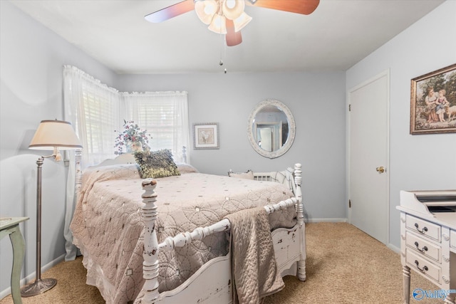 bedroom with a ceiling fan, light colored carpet, and baseboards