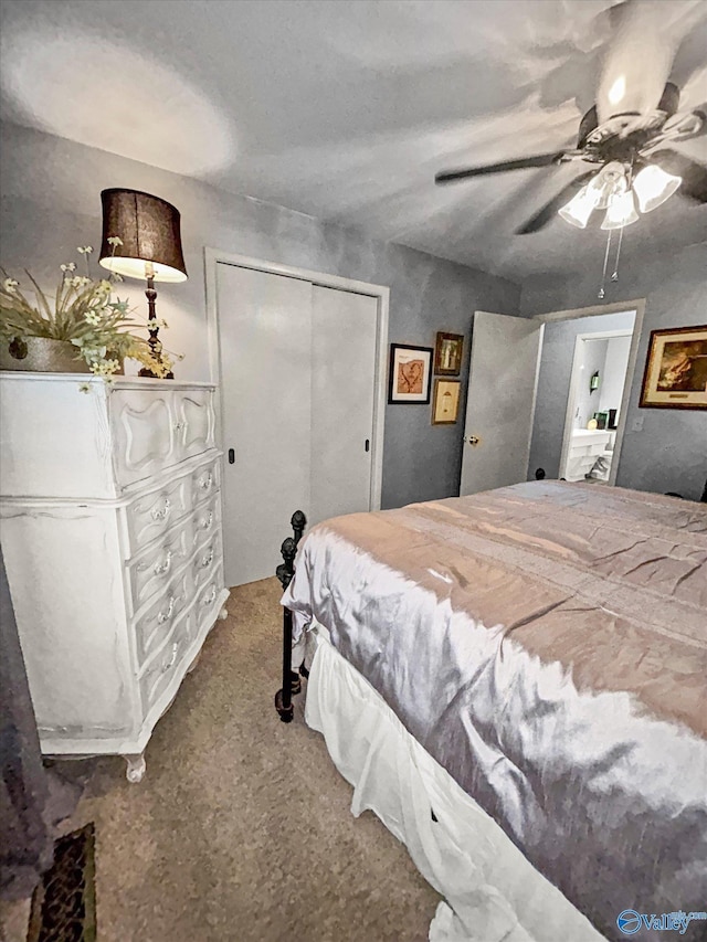 carpeted bedroom with ceiling fan and a closet