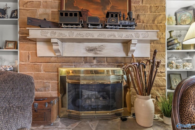 interior details featuring a stone fireplace