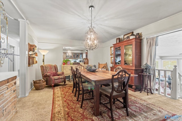 dining room featuring carpet floors and a chandelier