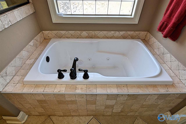 bathroom featuring tile patterned flooring and tiled tub